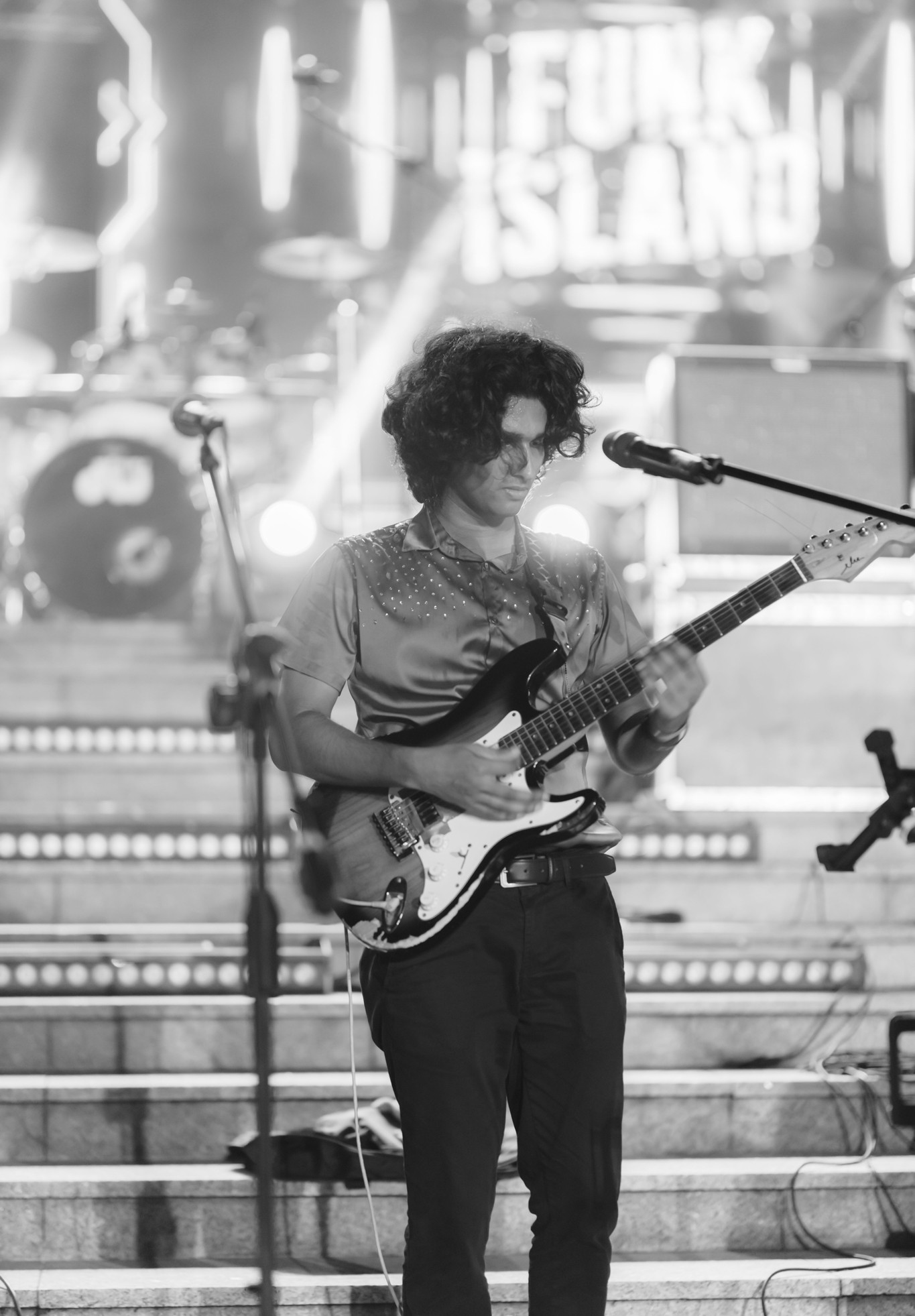 Guitarist performing in front of the Funk Island stage sign
