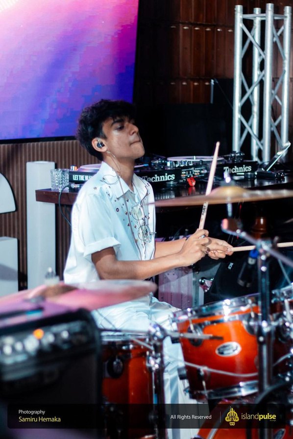 Thenu Jayakody playing drums with Funk Island